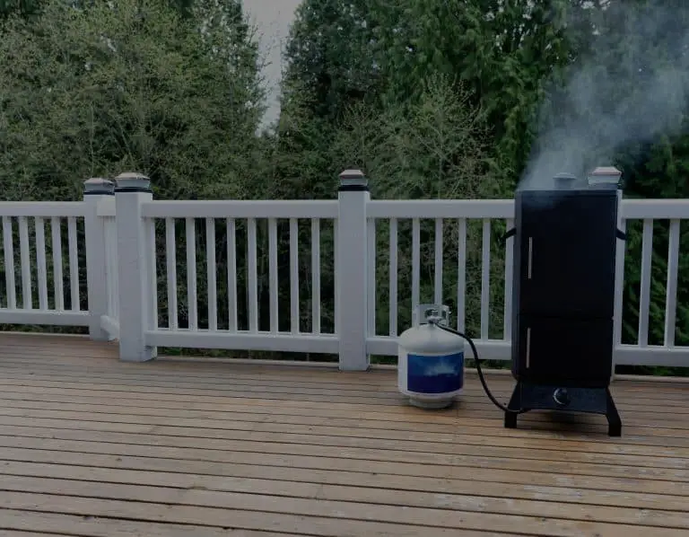 Backyard deck with smoker hooked up to propane