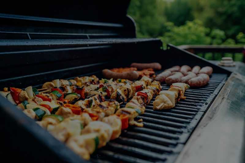roasting veggies and sausages on open bbq