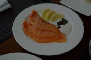smoked salmon on white plate with lemon