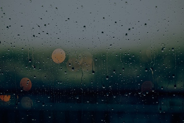 close up of rain on dark window