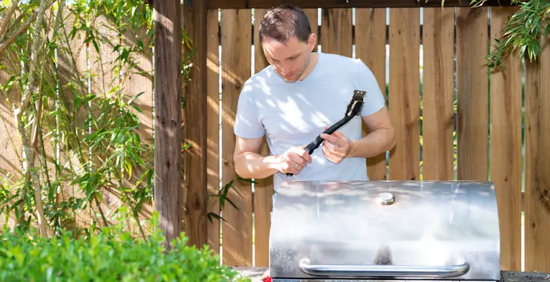 man cleaning smoker