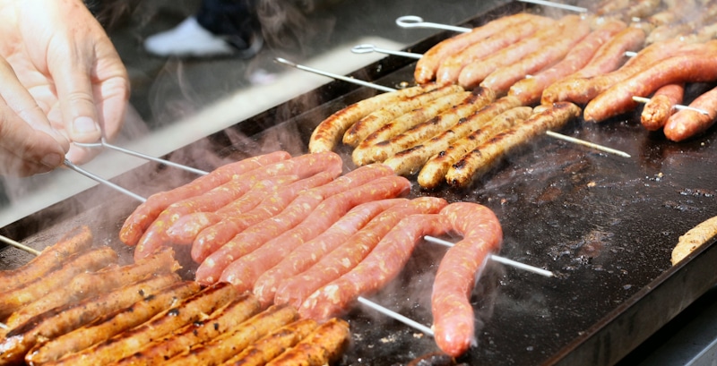 gas grill with hotdogs and sausages