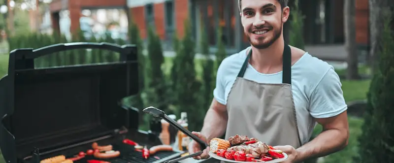 young man grill apron