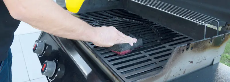 men clean grill